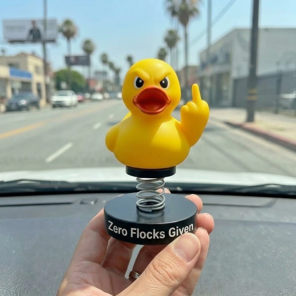 Hand holding yellow middle finger duck bobblehead with Zero Flocks Given base!