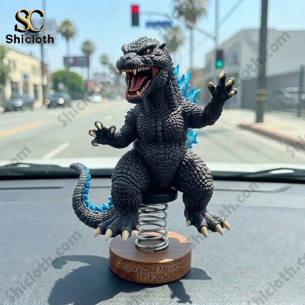 Godzilla anniversary bobblehead figure on car dashboard with city street background!