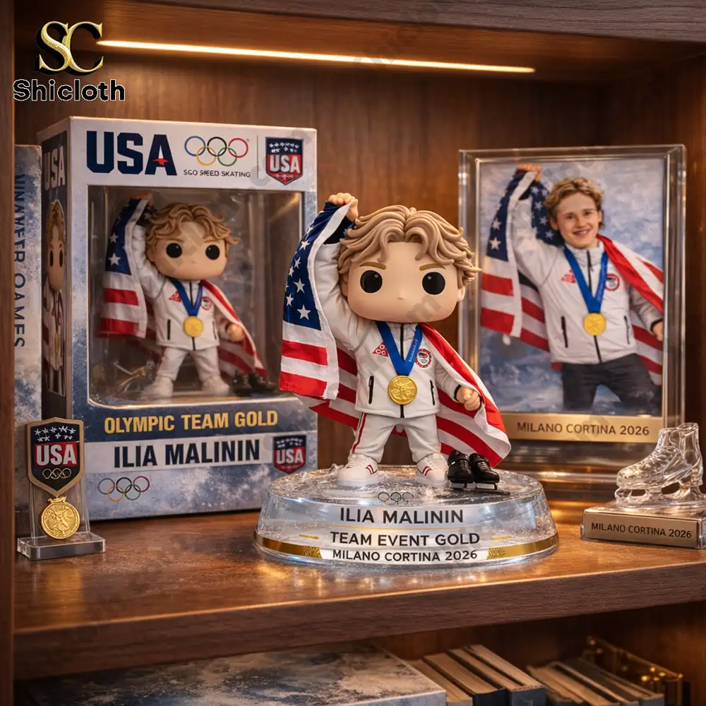 Ilia Malinin’s Olympic Team Gold Milano Cortina 2026 Funko figure displayed in a collector’s shelf, with a framed photo of him and other Olympic memorabilia.