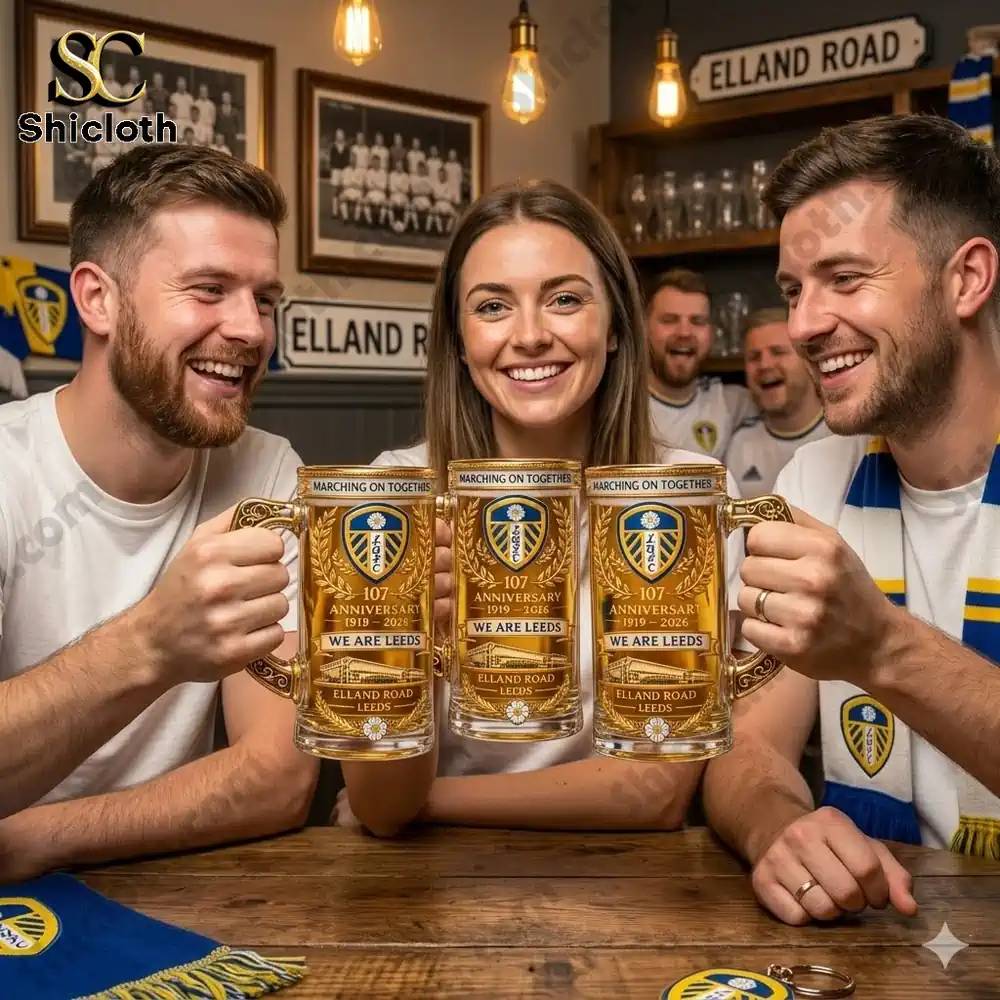 Group of Leeds United fans holding anniversary beer mugs in a bar