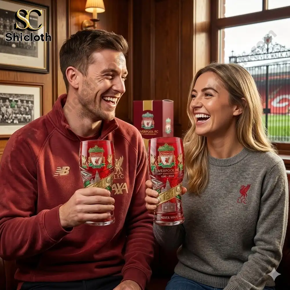 Liverpool fans holding liverpool fc one hundred thirty four anniversary beer whisky glasses in a warm pub near stadium atmosphere!
