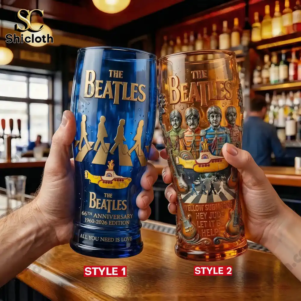 Two Liverpool Sound The Beatles anniversary beer glasses held in hands inside a warm bar setting!