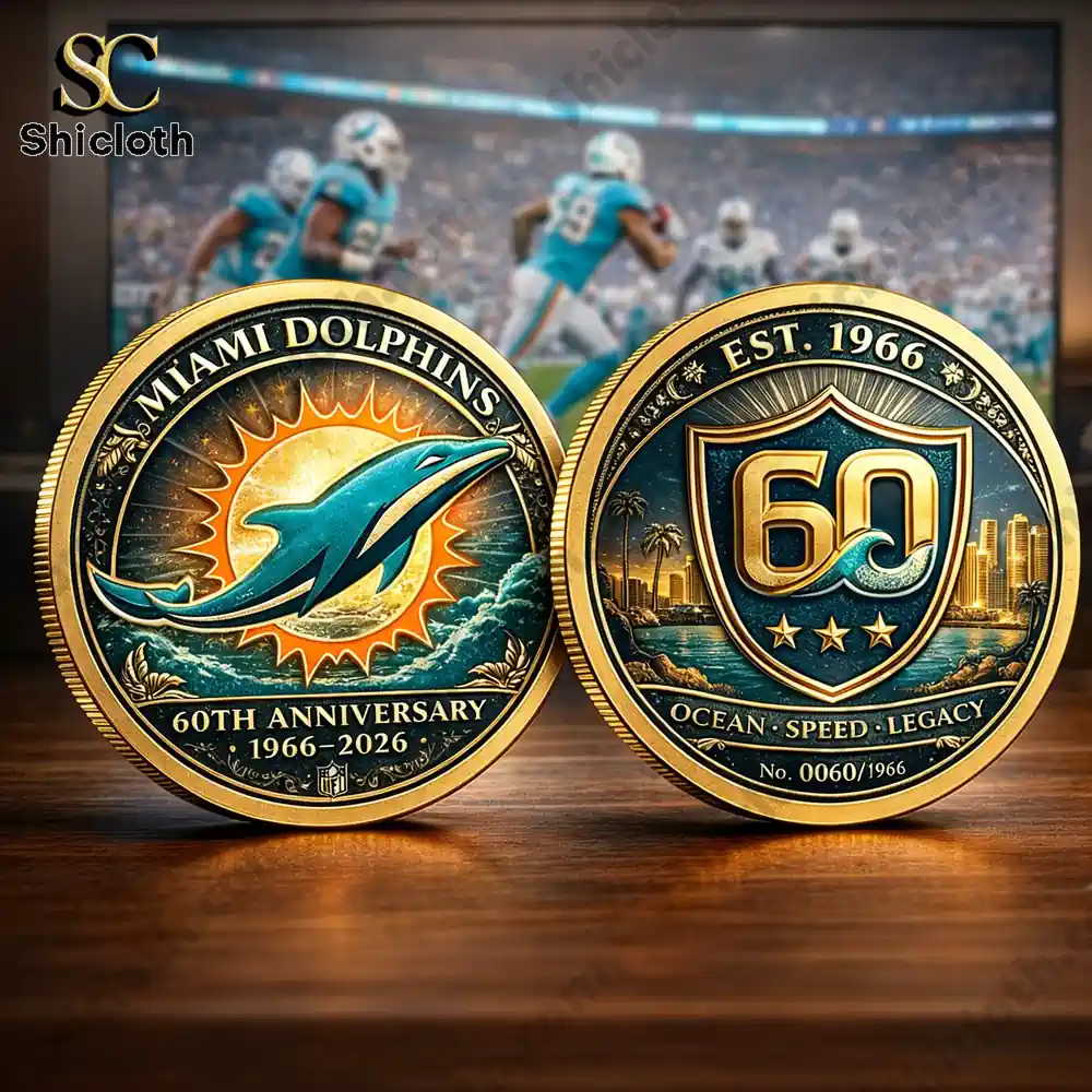 Miami Dolphins sixtieth anniversary commemorative coin front and back displayed on a table before a football stadium scene!