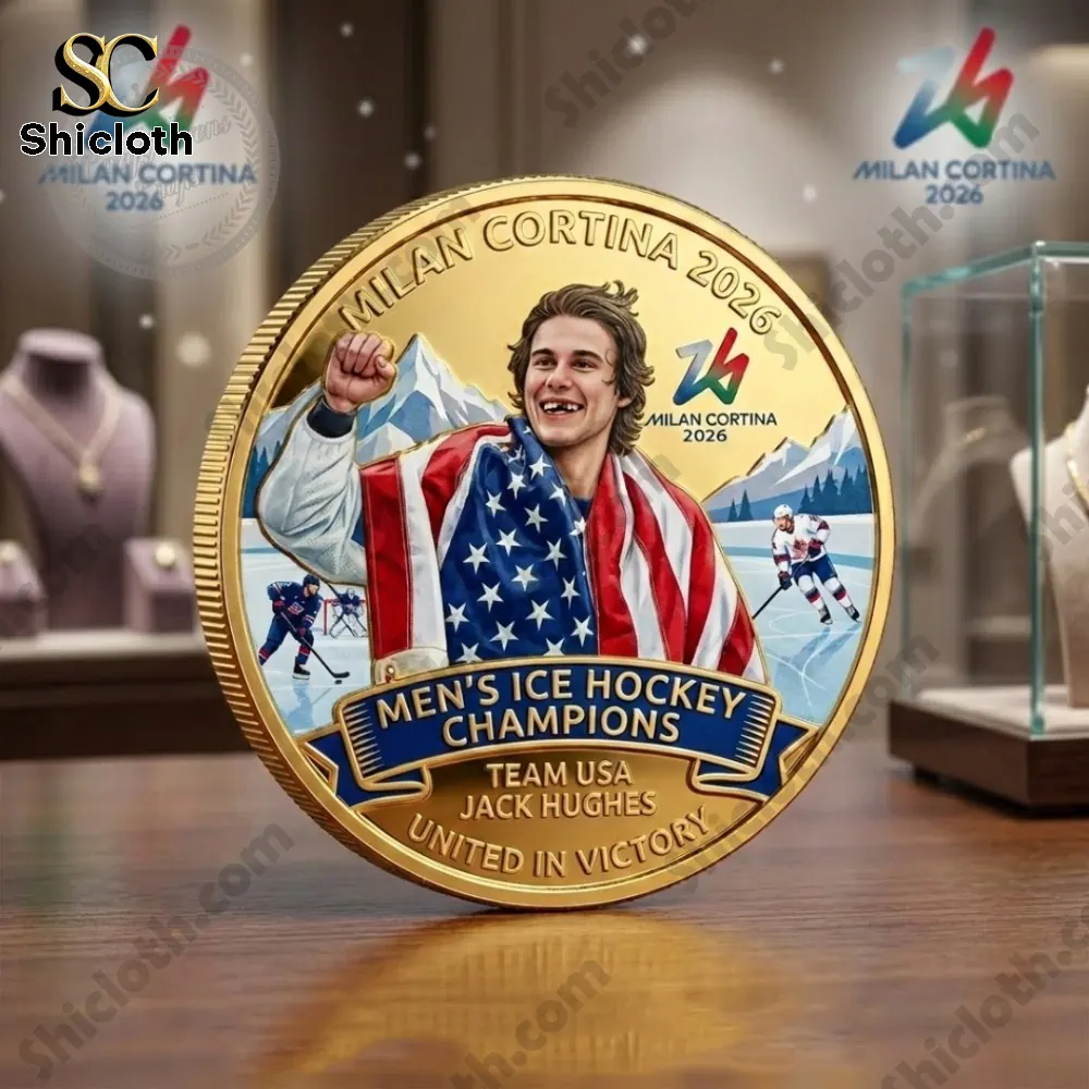 Gold commemorative coin of Team USA hockey champion Jack Hughes for Milan Cortina Twenty Twenty Six displayed on table in showroom!