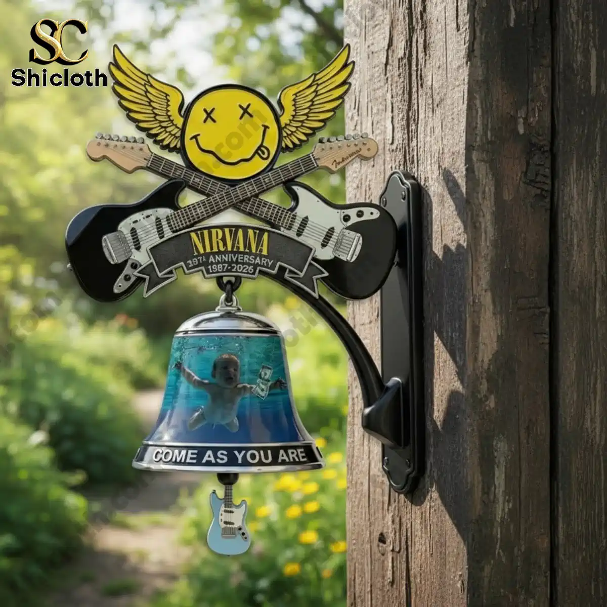 Nirvana anniversary wall bell mounted on wooden post outdoors with garden background