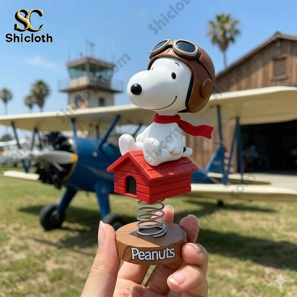 Snoopy flying ace bobblehead sitting on red doghouse held in hand at small airport scene!