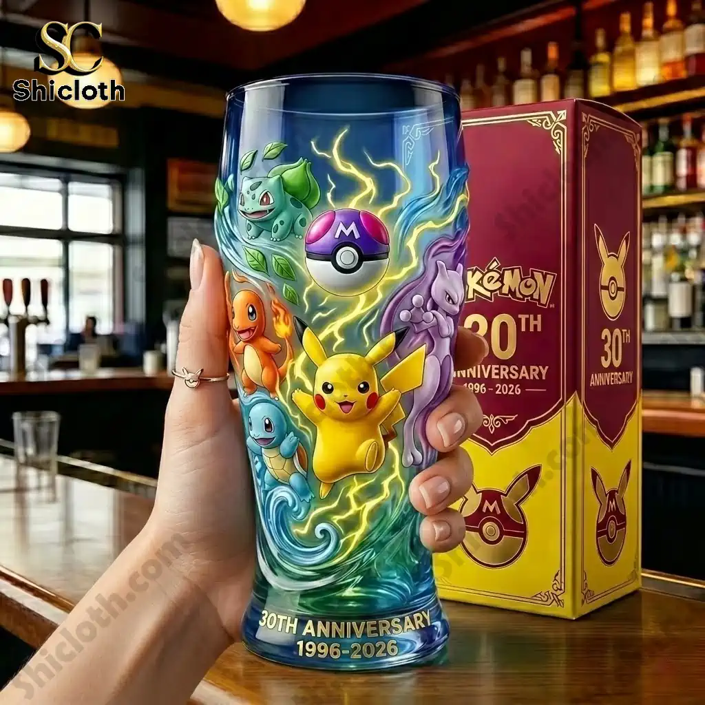 Close up of Pokemon 30th Anniversary commemorative glass held in hand with Shicloth box behind