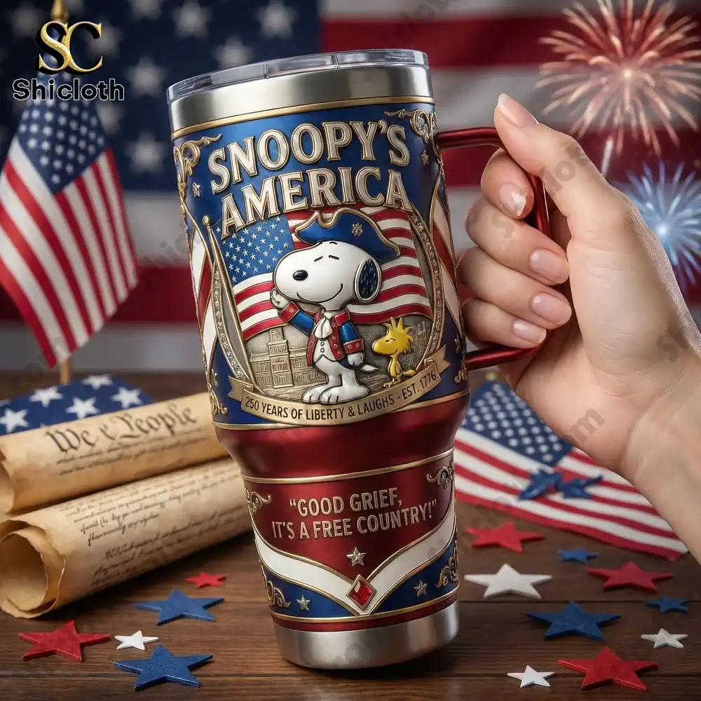 Hand holding Snoopy America anniversary tumbler with American flag background by Shicloth!