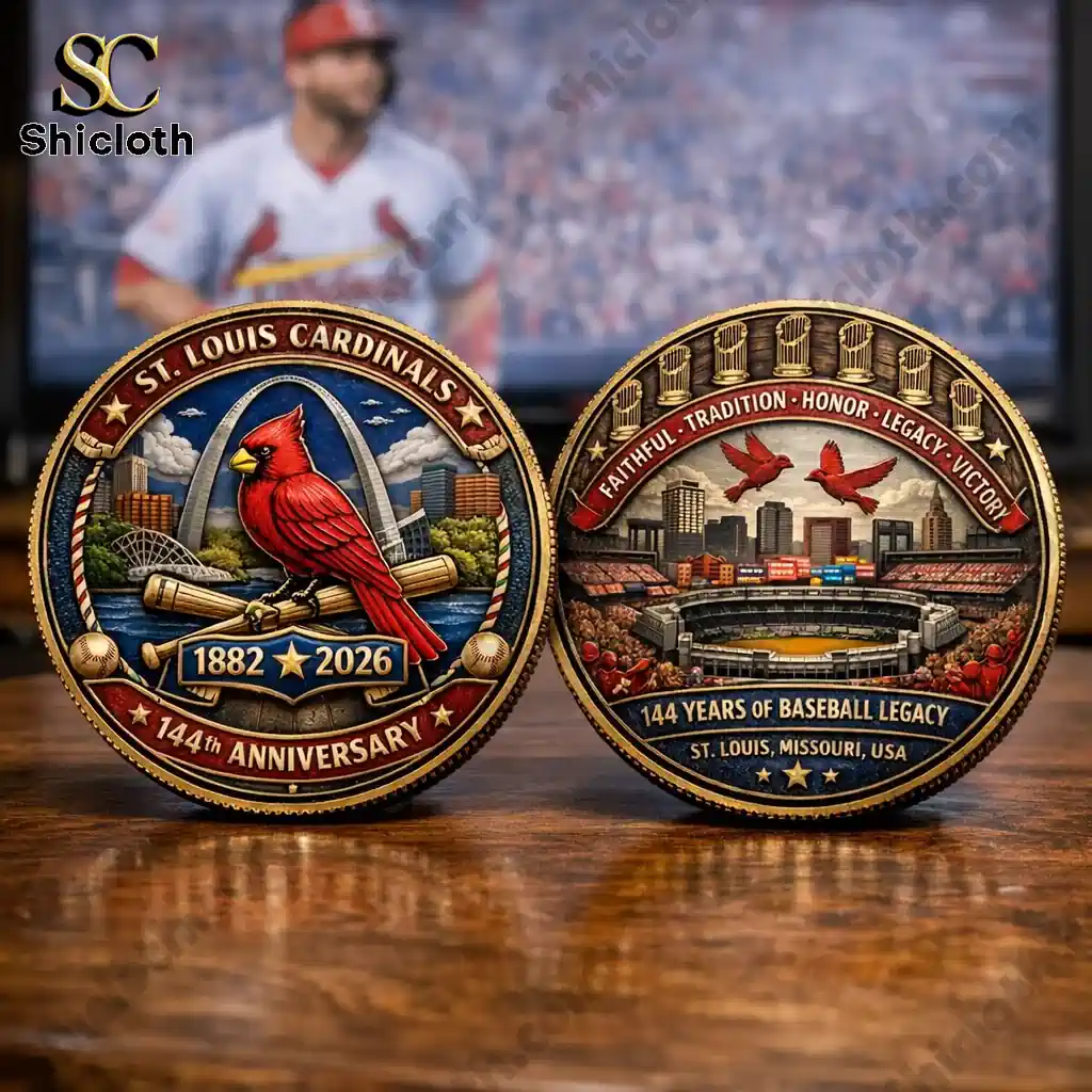 Front and back of St Louis Cardinals 144th anniversary commemorative coin on wooden table