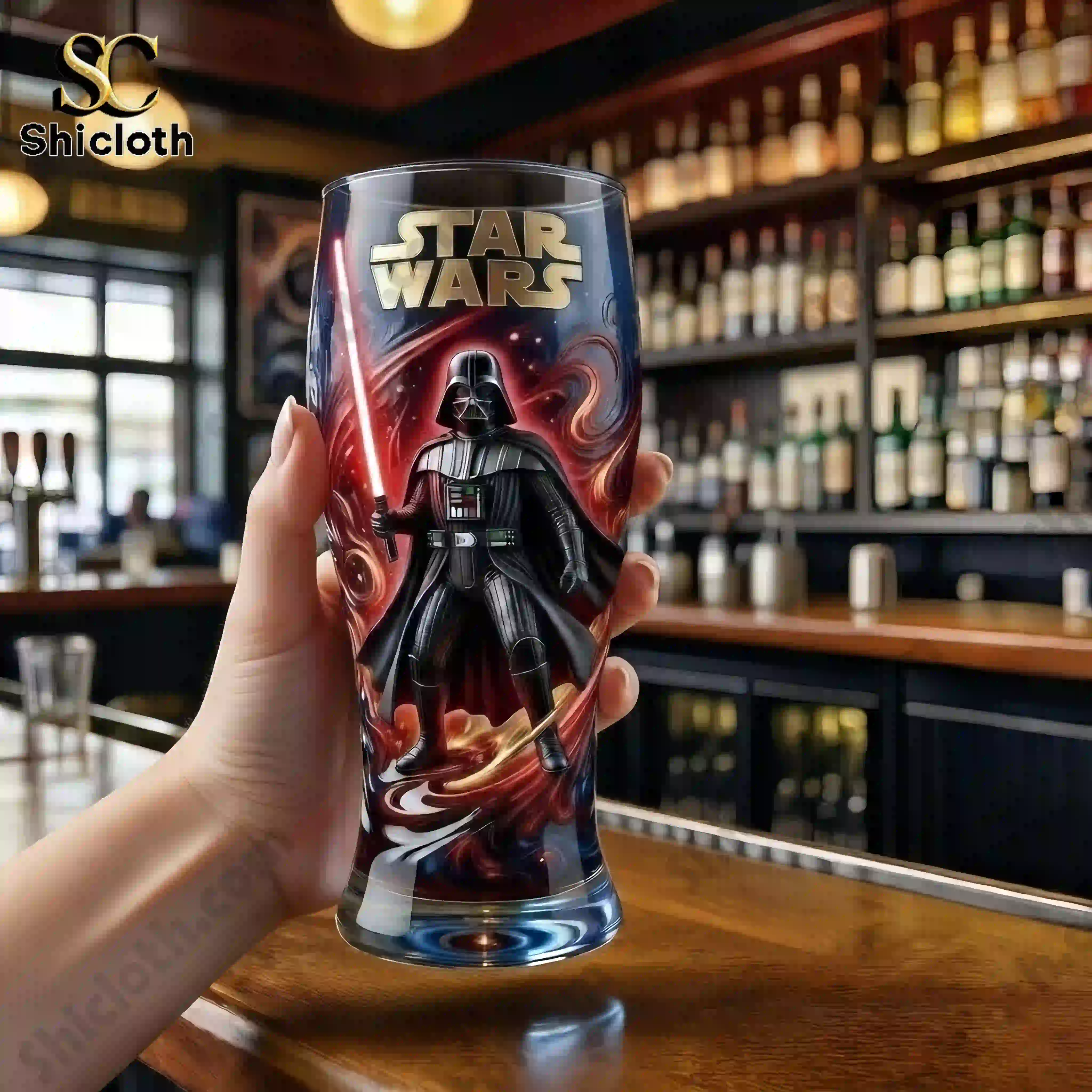 Close up of Star Wars Darth Vader commemorative glass held by hand in bar