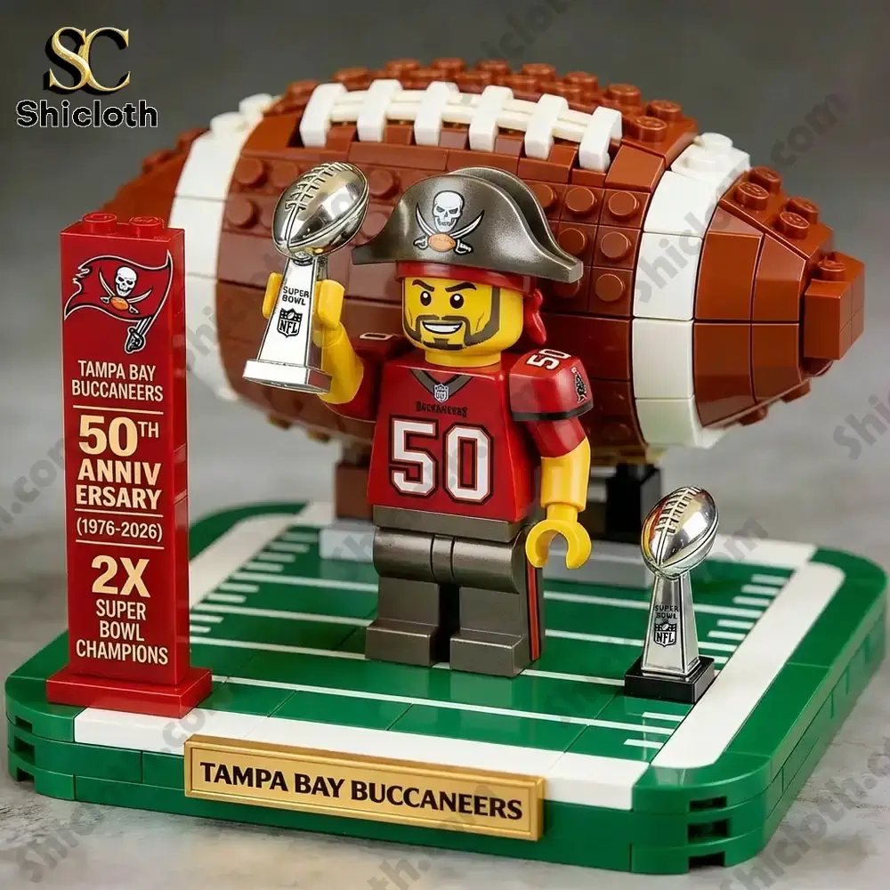 Brick figure holding trophy in front of large football display!