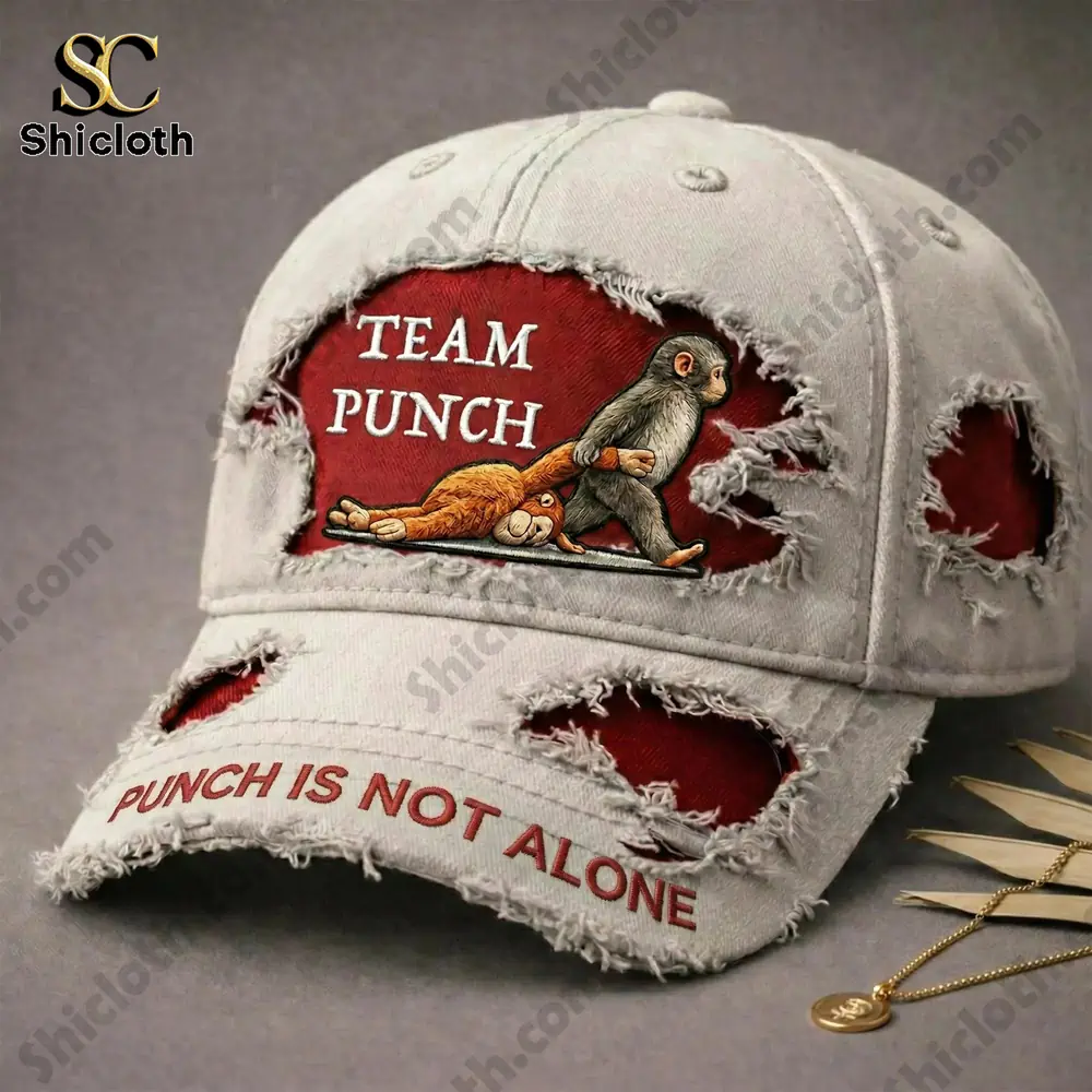 The Team Punch cap featuring a playful "Punch is Not Alone" slogan, with a distressed look and monkeys depicted on the front panel.