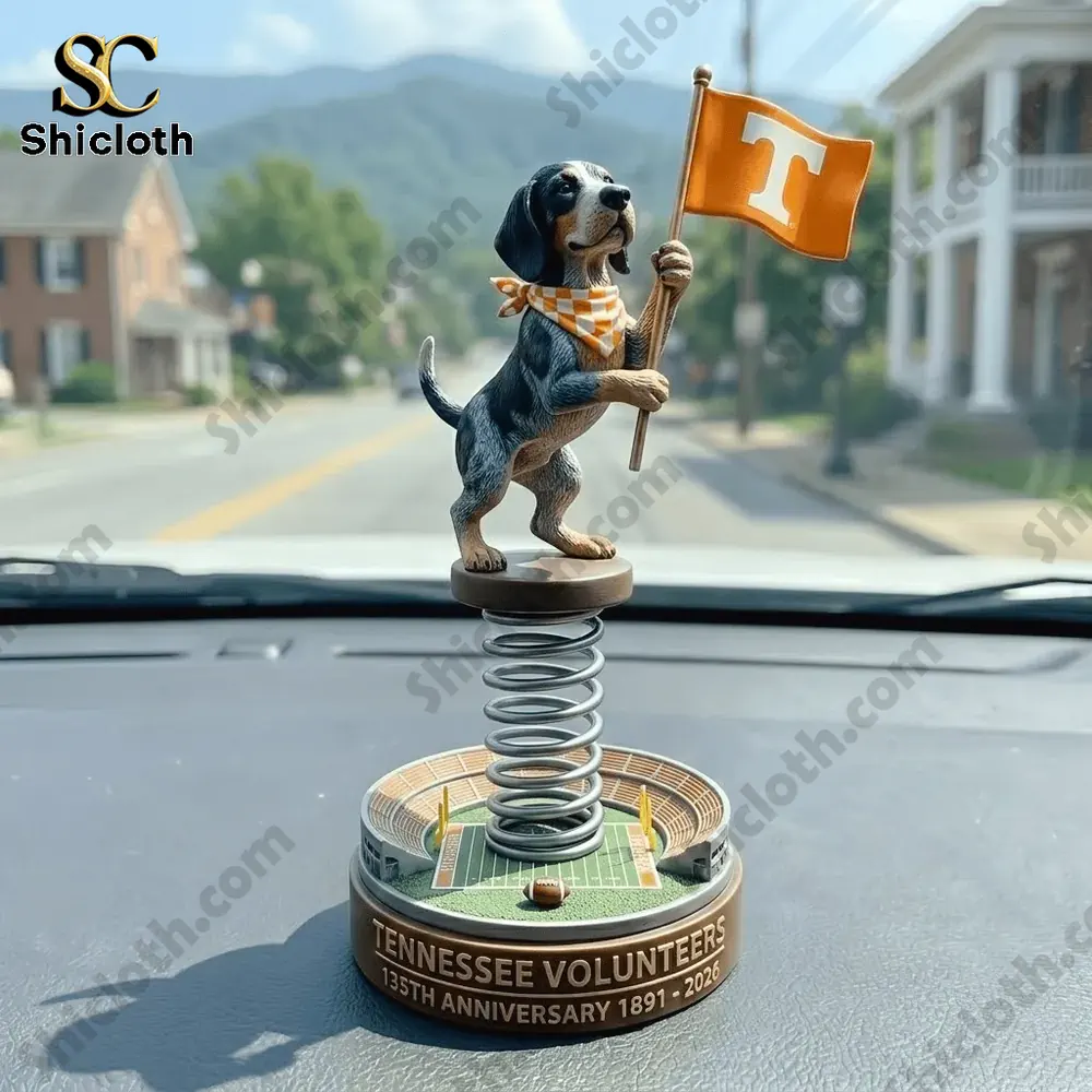 Dog bobblehead holding orange Tennessee flag on spring base placed on car dashboard!