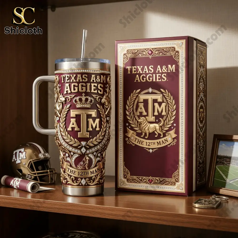 Texas A and M themed insulated tumbler with ornate design next to matching gift box on wooden shelf