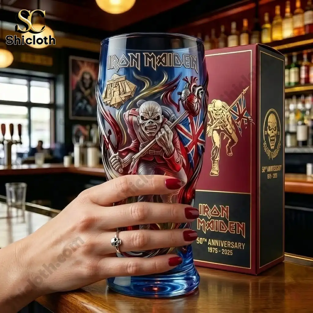Close up of Iron Maiden fiftieth anniversary beer glass held by a hand beside commemorative box!