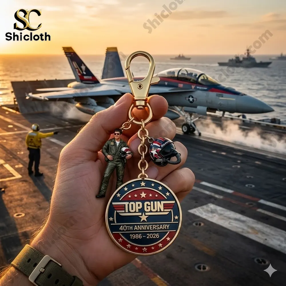 Hand holding top gun anniversary keychain with pilot charm on aircraft carrier at sunset by shicloth!