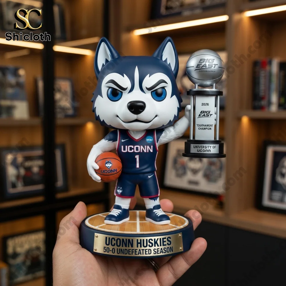 Uconn husky mascot figure holding basketball and championship trophy