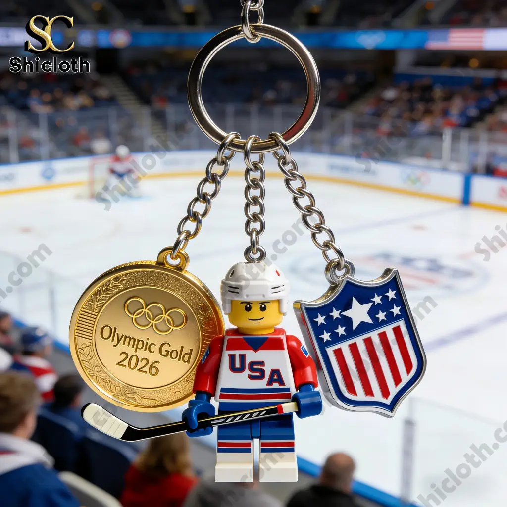 Close up USA Hockey Olympic Gold 2026 keychain with medal figure and shield