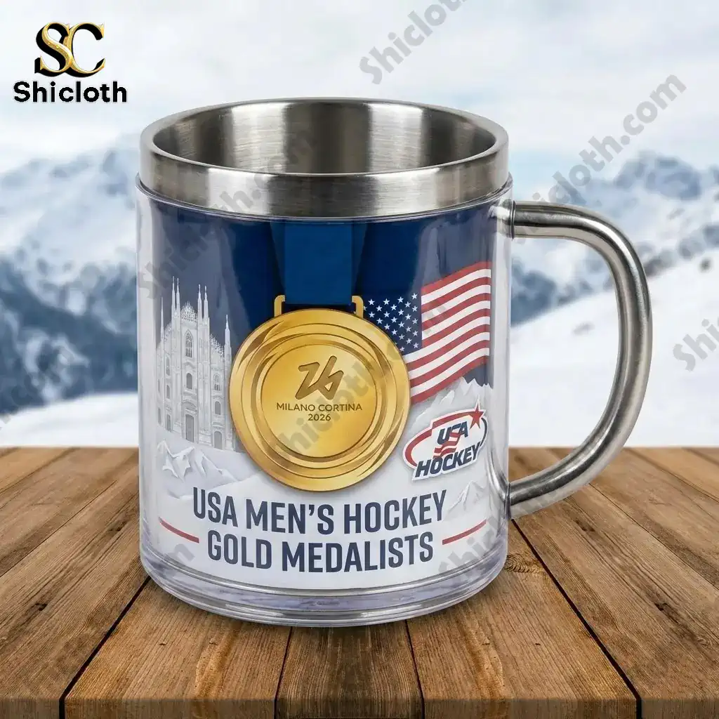 Close up of USA Mens Hockey Gold Medalists stainless steel mug with gold medal design on wooden table.
