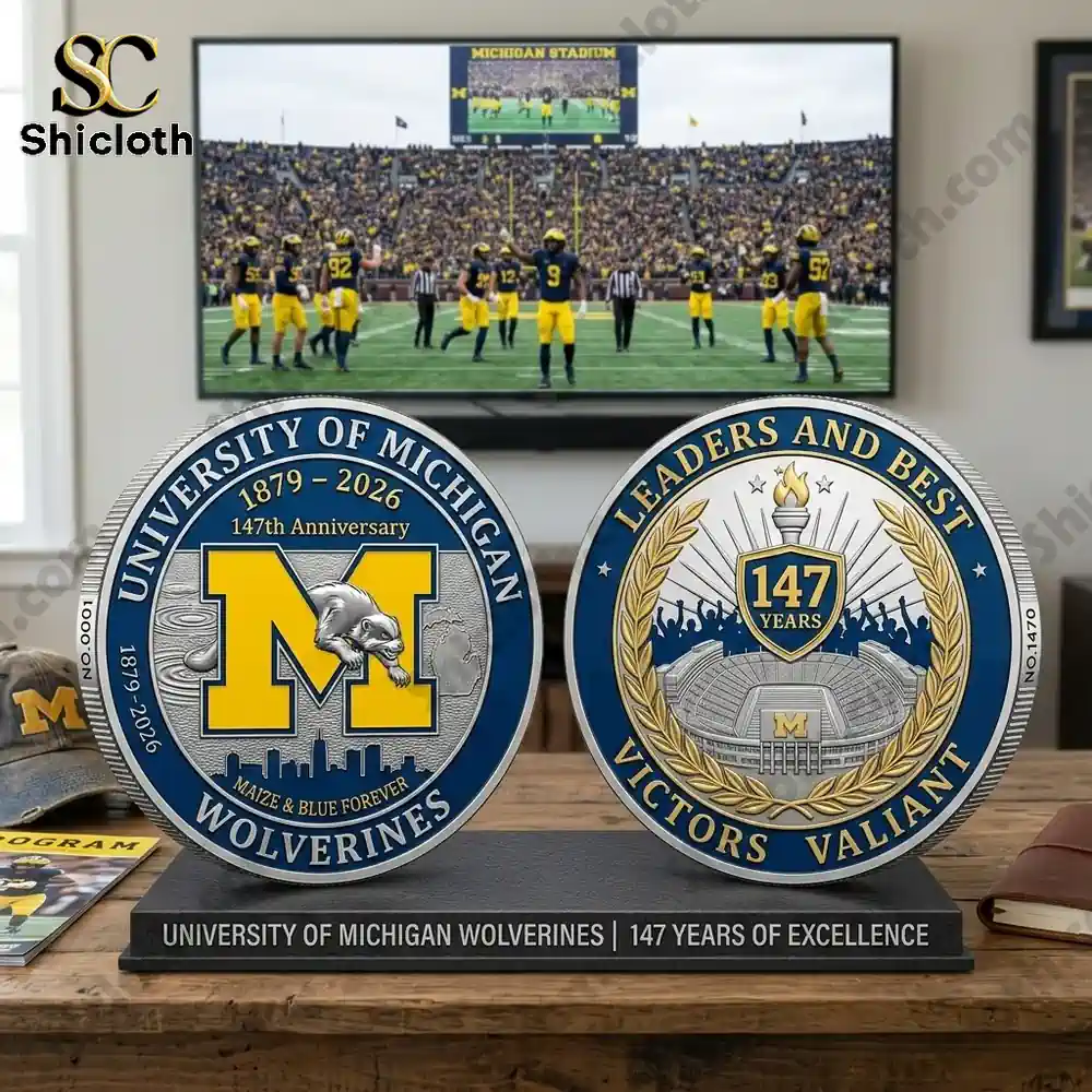 Front and back University Michigan Wolverines anniversary coin on display stand in fan room!