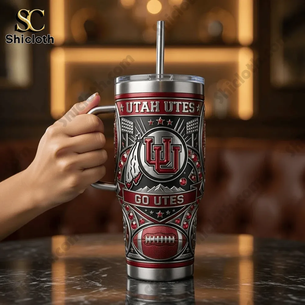 Hand holding Utah Utes tumbler in warm indoor setting