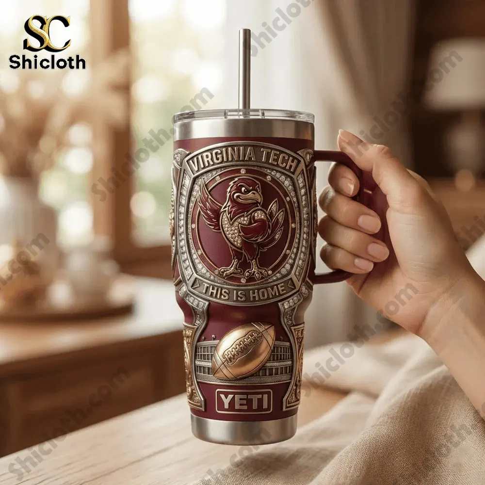 Hand holding Virginia Tech Yeti tumbler in a cozy indoor setting!