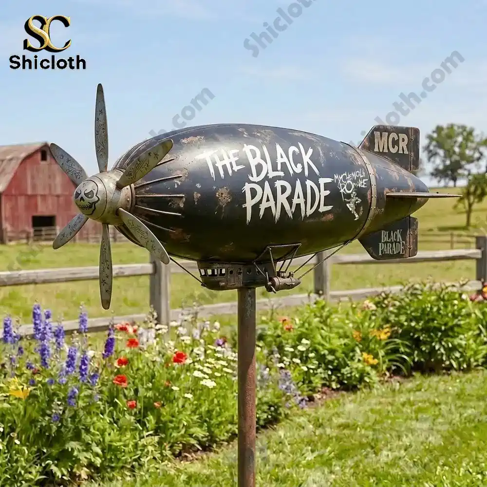 Black parade themed garden wind spinner shaped like a small airship in a flower garden