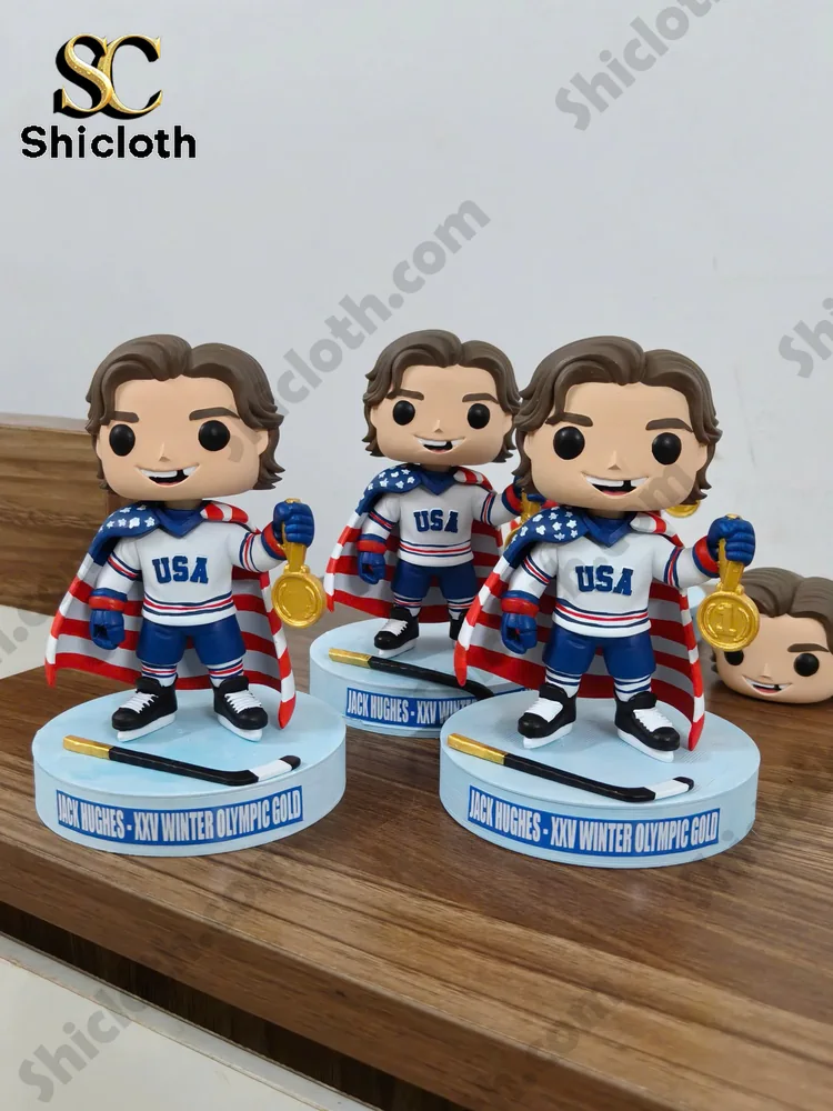 Jack Hughes USA hockey collectible figure holding a gold medal with an American flag cape!