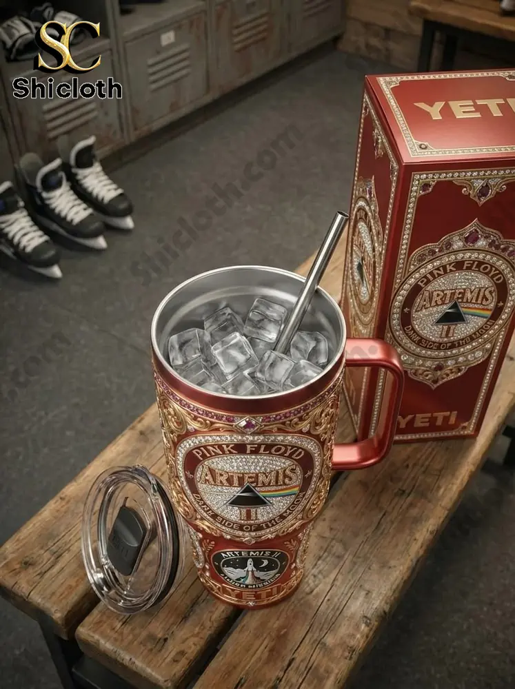 Red Artemis Pink Floyd YETI tumbler with ice beside box on wooden table