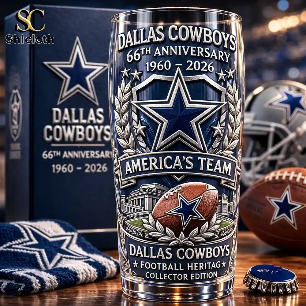 Close up of Dallas Cowboys anniversary collector beer glass with team items on table