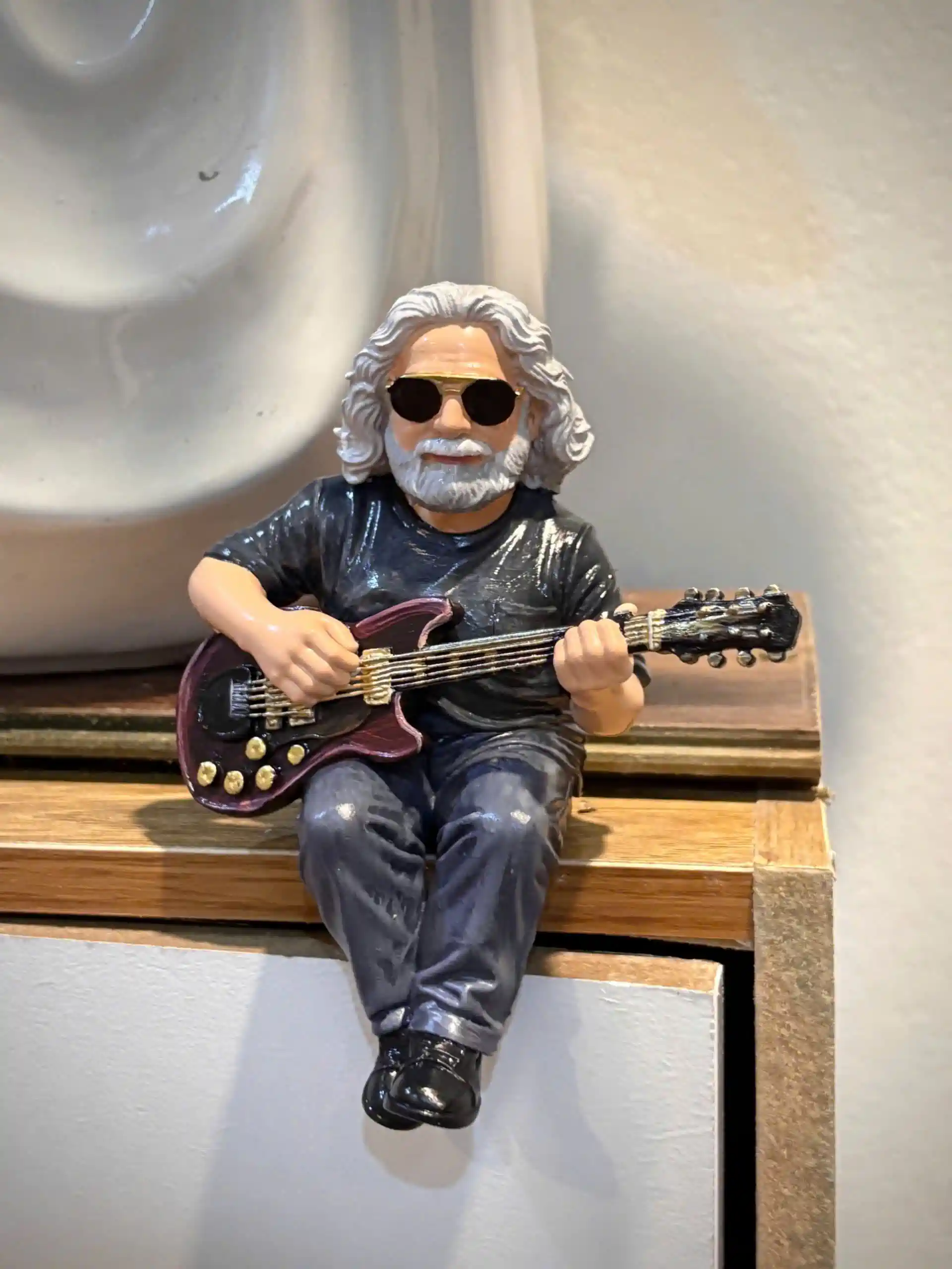 Front view miniature man with gray hair sunglasses playing guitar!