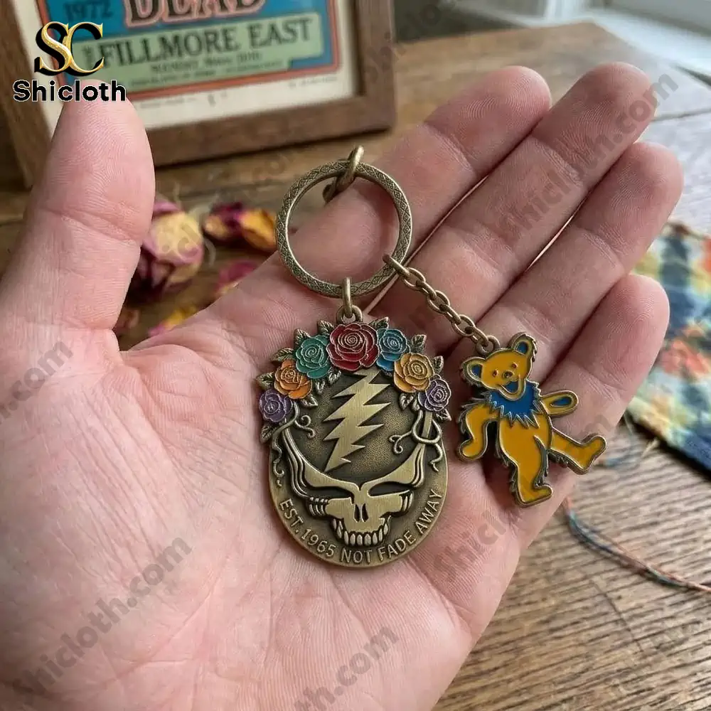 Hand holding detailed skull lightning keyring with bear charm