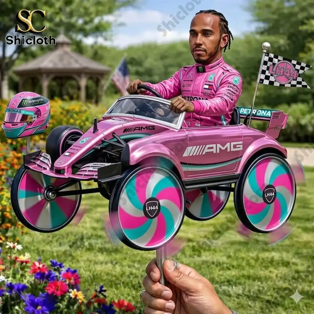 Hand holding pink racing car wind spinner in garden setting