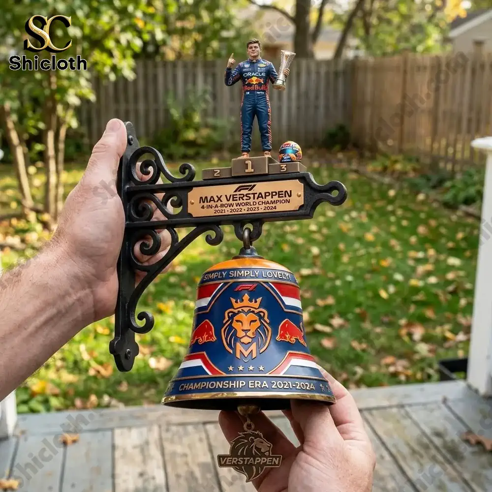 Hand holding Max Verstappen themed wall bell outdoors