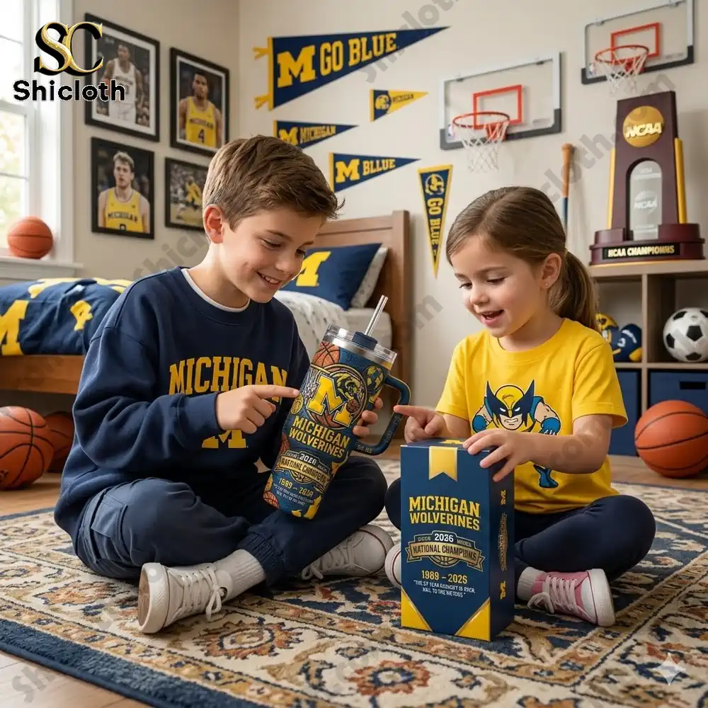 Two kids holding a Michigan Wolverines tumbler in a sports themed bedroom!