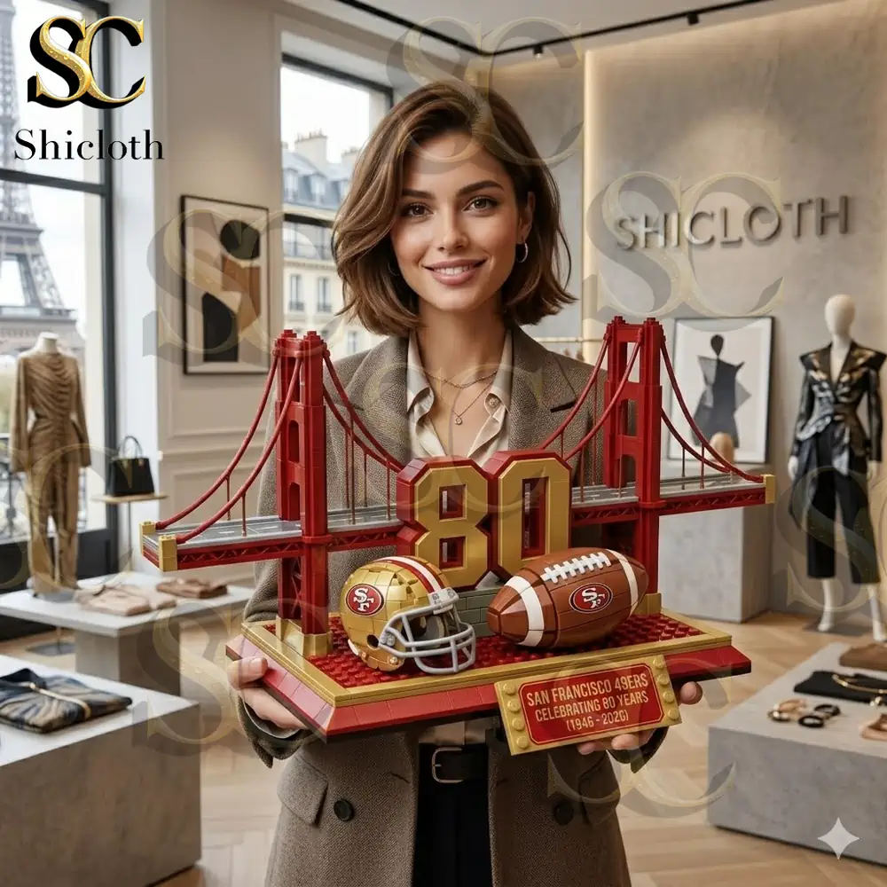 A smiling woman holding a San Francisco 49ers 80th anniversary commemorative brick set featuring the Golden Gate Bridge and a football helmet!
