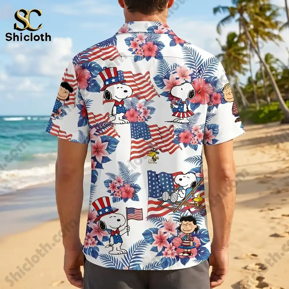 Rear view of a man on a beach wearing a short sleeve Hawaiian shirt with a colorful patriotic Snoopy and American flag pattern!