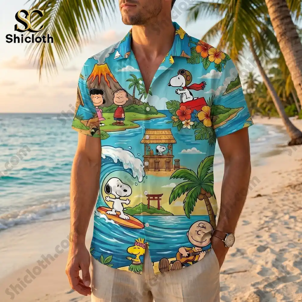 A man wearing the Peanuts Aloha beach vacation shirt while standing on a tropical beach with palm trees.