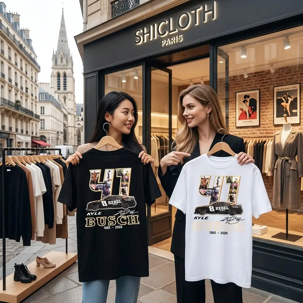 Two women holding custom Kyle Busch tribute t-shirts outside a boutique in Paris.
