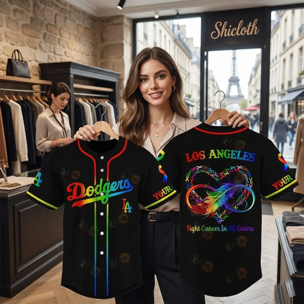 Woman holding a black Los Angeles Dodgers cancer awareness jersey in a clothing store with Eiffel Tower view
