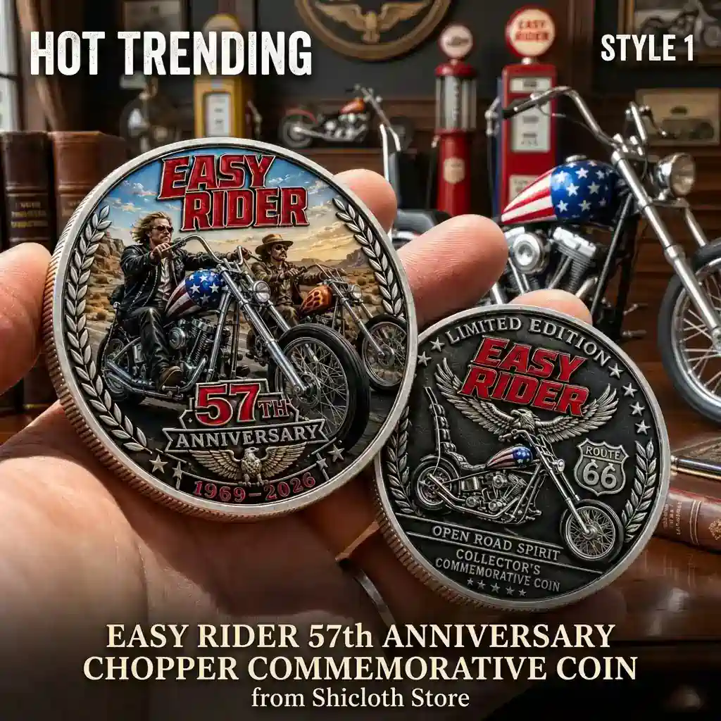 A person holding two metal commemorative coins featuring chopper motorcycles and Easy Rider branding in front of a garage background!