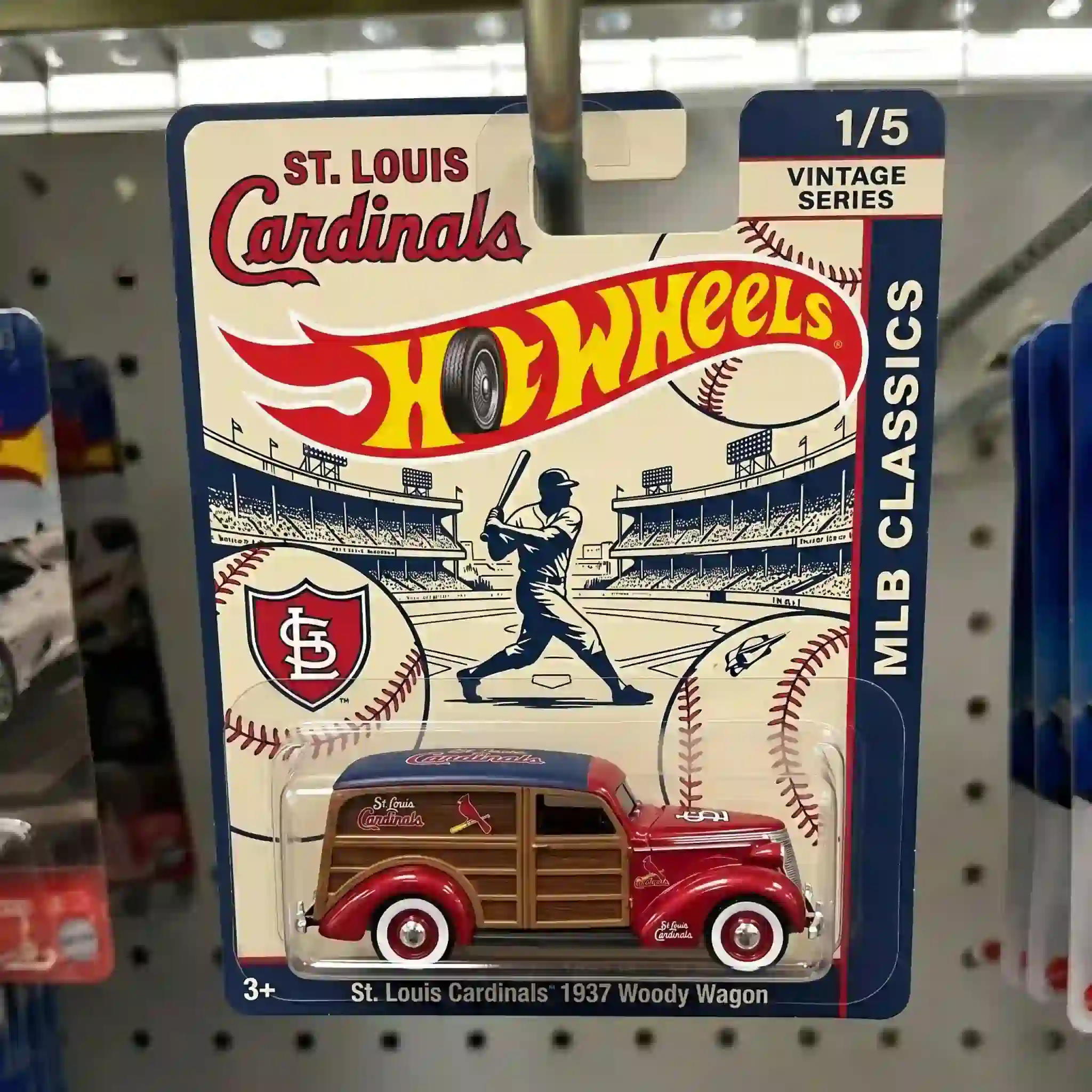 Close-up of Hot Wheels St. Louis Cardinals 1937 Woody Wagon packaging showing baseball stadium illustration.
