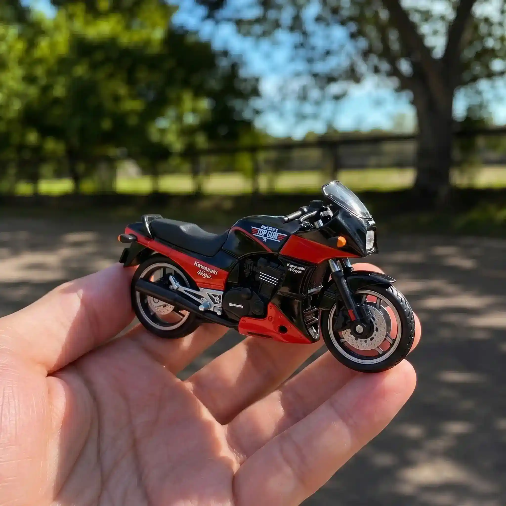 Hot Wheels Top Gun 40th Anniversary Maverick's Kawasaki GPZ900R 3 Hot Wheels Top Gun Maverick Kawasaki GPZ900R toy held outdoors