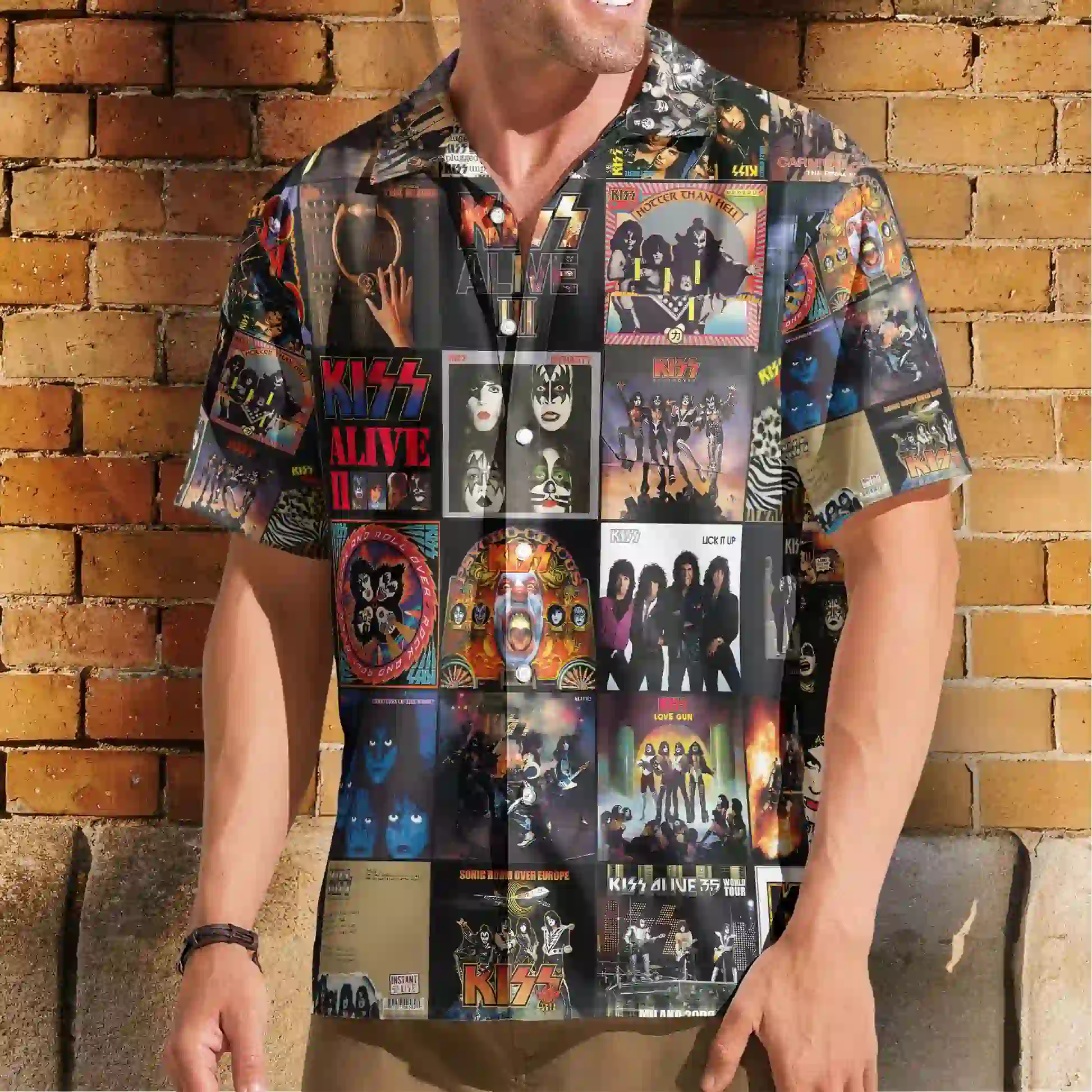 Man wearing a button-down shirt featuring a collage of vintage KISS album covers