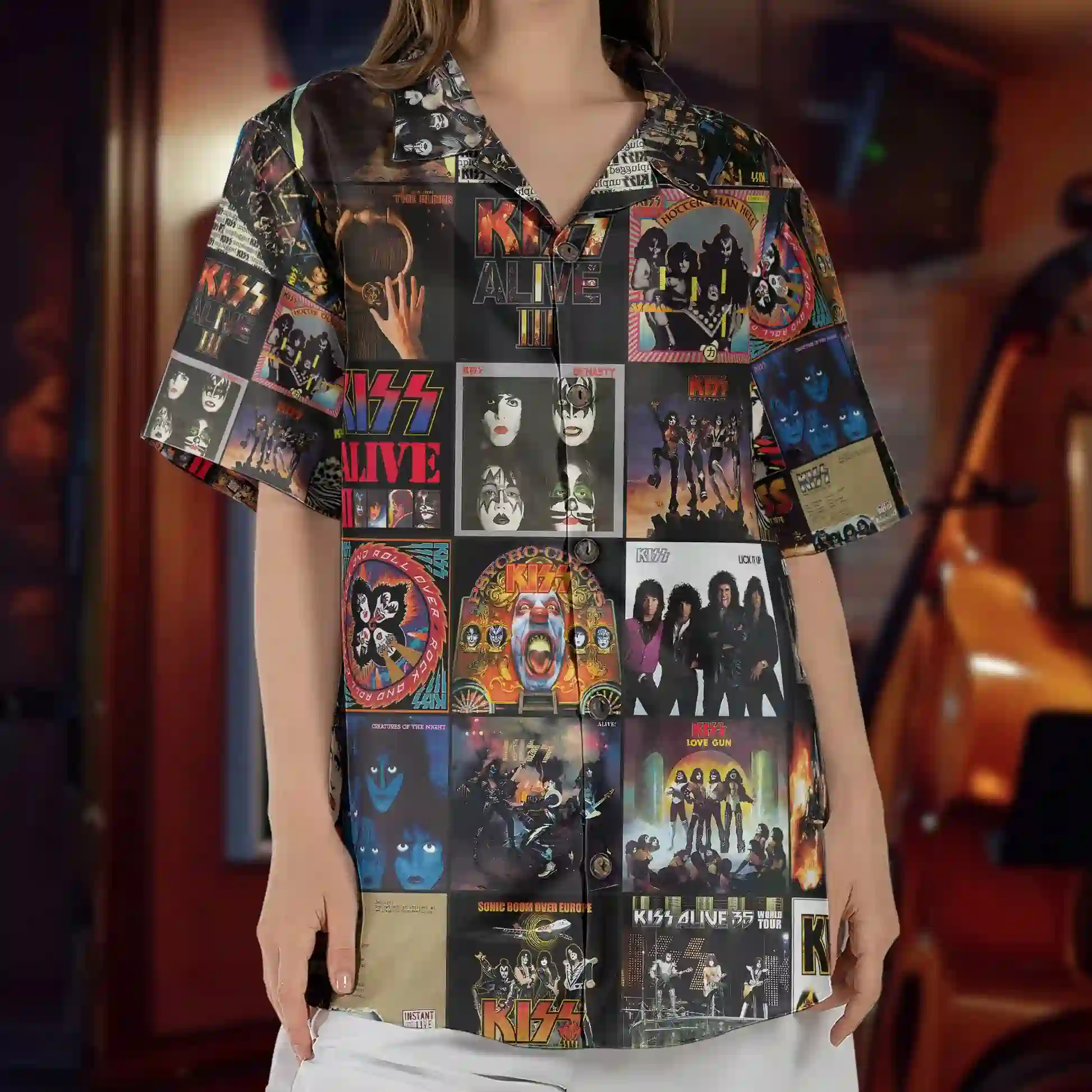 New Kiss Band Album Cover Collage Glam Rock Hawaiian Shirt 4 A person wearing a short-sleeve collared shirt featuring a montage of iconic KISS album covers and band artwork.