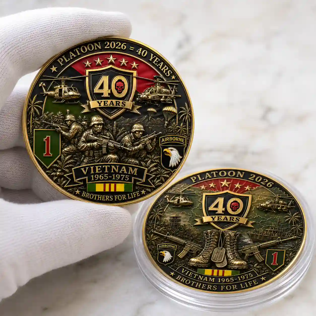 PLATOON VIETNAM 1965-1975 40th Anniversary Memorial Coin 3 Gloved hand holding the front side of a gold Platoon Vietnam war memorial coin next to the back side in a plastic case