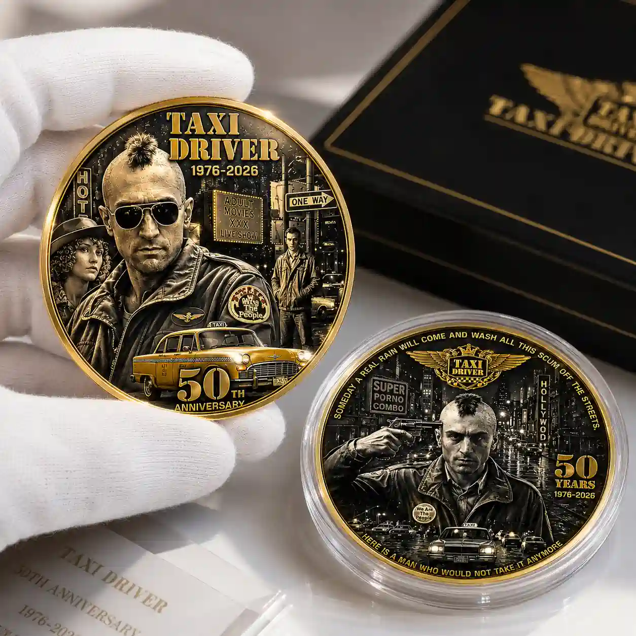 Close up view of the gold and silver Taxi Driver fiftieth anniversary collector coins side by side with their black presentation box!
