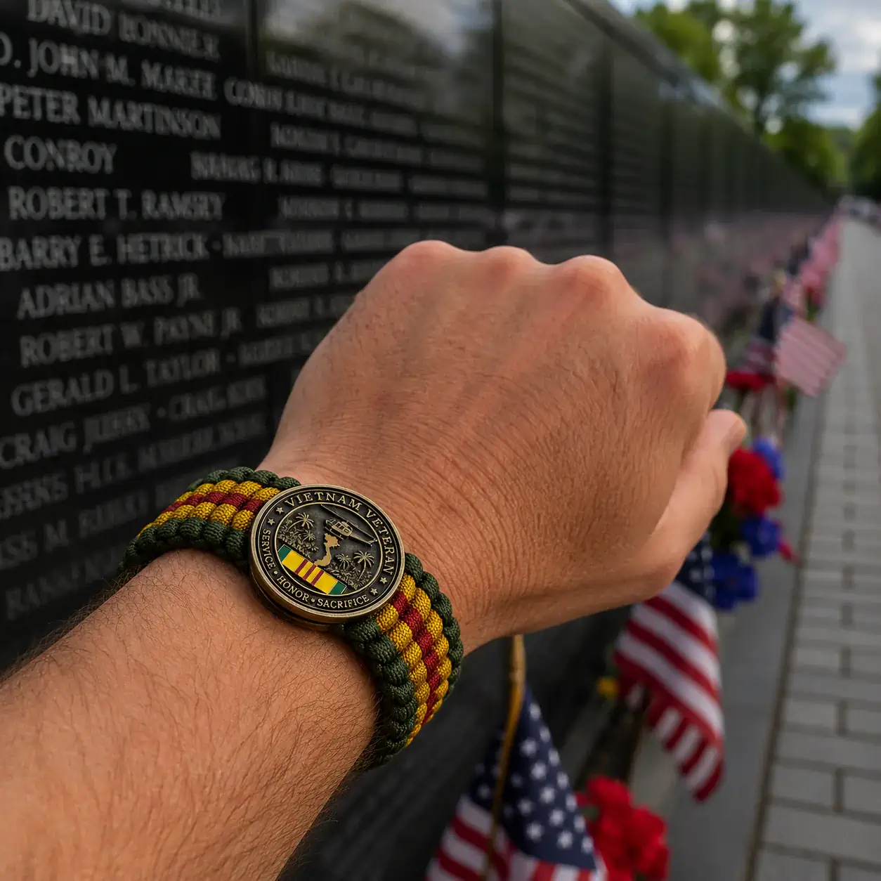 Vietnam Veteran Survival Tribute Paracord Bracelet 4 Vietnam Veteran Survival Tribute Paracord Bracelet worn near memorial wall with flags