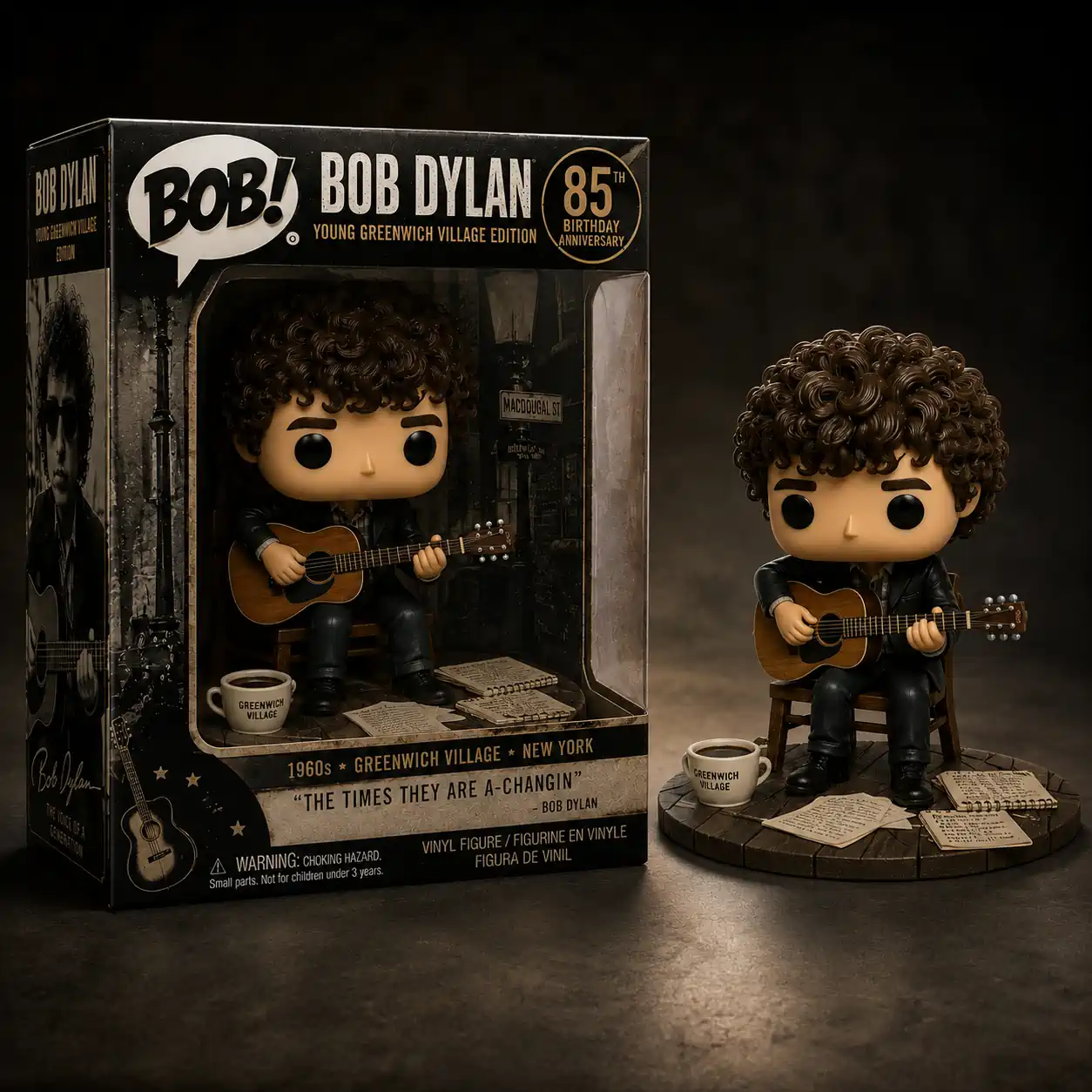 Young Greenwich Village Bob Dylan 85th Birthday Anniversary Edition Funko Pop! Figure 3 A young Bob Dylan style vinyl figure sits playing an acoustic guitar on a simple circular stand! It has a coffee cup and loose papers at its feet! It is placed beside its closed collector box featuring black and white images! The entire setup is shown against a plain dark studio background!